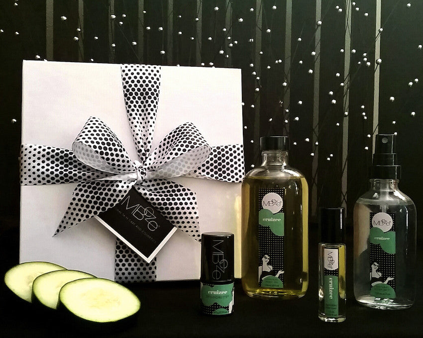 Cruizee Deluxe Collection with gift box, Deodorette, Body Oil, Perfume, Body Mist, and cucumber slices.