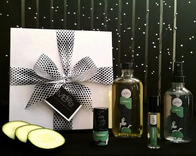 Cruizee Deluxe Collection with gift box, Deodorette, Body Oil, Perfume, Body Mist, and cucumber slices.