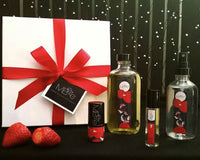 MBeze Ife Deluxe Collection with gift box, including Deodorette, Body Oil, Perfume, and Body Mist, with strawberries in front.