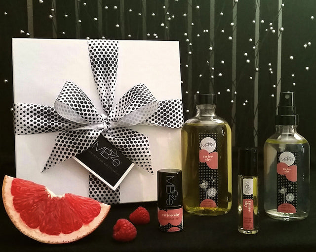 MBeze Twice Shy Deluxe Collection with gift box. Including Deodorette, Body Oil, Eau de Toilette, and Body Mist, with a slice of grapefruit and raspberries.